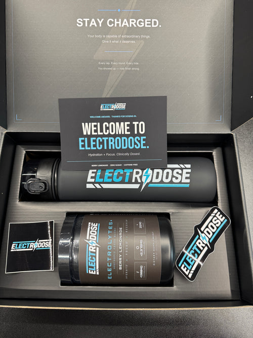 Electrodose welcome kit — Berry Lemonade tub, insulated shaker bottle, stickers, and welcome card in the Stay Charged gift box